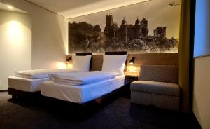 Säng eller sängar i ett rum på Euro Hotel Wertheim