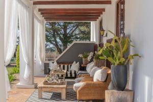 a living room with a couch and chairs and a table at Lairds Lodge Country Estate in Plettenberg Bay
