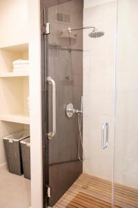 a shower with a glass door in a bathroom at 1906 Mission in San Francisco