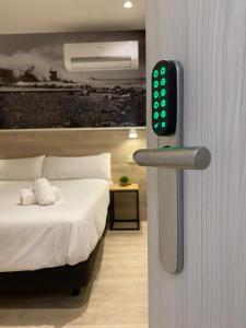 a room with a bed and a smart watch on a wall at MIROTZA ROOMS AND APARTMENTS in Orio