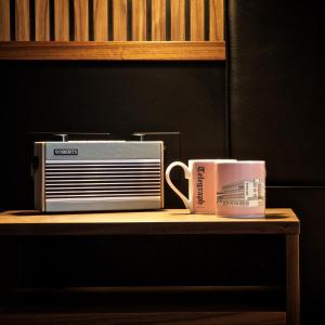 two coffee cups sitting on a table next to a toaster at Telegraph Hotel - Coventry in Coventry