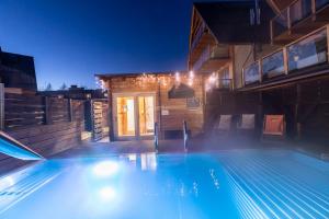 a swimming pool in a house at night at POD SKOCZNIA SPA Zakopane in Zakopane