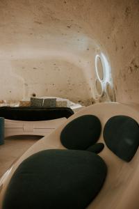 a bedroom with two beds with green cushions at Maison Paola Di Serio in Matera