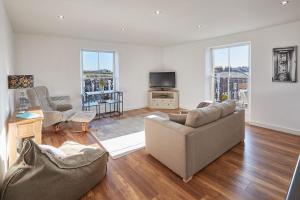 a living room with a couch and a tv at Host & Stay - Abbey Court Apartment in Whitby