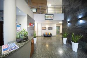 a lobby with potted plants and a couch at Hotel Dal Kielce in Kielce
