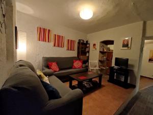 a living room with a couch and a table at Casa Rural El Trepador Azul in Cabeza la Vaca