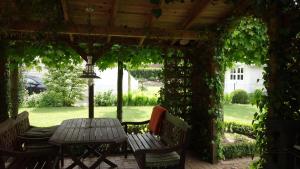 a patio with a table and chairs under a pergola at Ferienhaus Schwalbenrast in Lembruch
