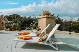 a table and two chairs next to a swimming pool at Hotel Al Mulino in Anacapri