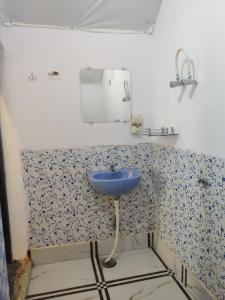 a bathroom with a sink and a mirror at H7Stay Luxury Cottages And Camps, Rishikesh in Rishīkesh