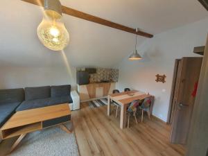 a living room with a couch and a table at Comfort Home Studio in Petroşani