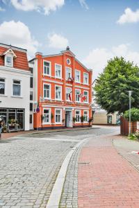 un edificio naranja al lado de una calle en Hotel Stadt Kappeln, en Kappeln