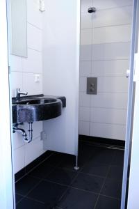 a bathroom with a sink and a mirror at Dünencamping Amrum in Wittdün