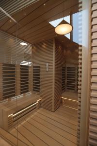 a sauna with wooden blinds and a light at The Veil Hotel in Astana