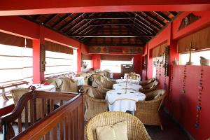 a dining car of a train with tables and chairs at Raheem Residency in Alleppey