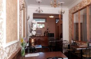 a dining room with tables and chairs and a vase of flowers at Les Terrasses de Saillans in Saillans