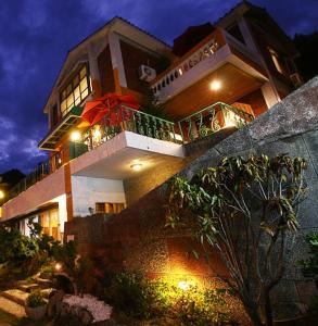 a large building with a balcony with lights at Sunny Ocean B&B in Yanliau