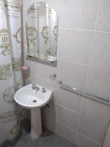 a bathroom with a sink and a shower with a mirror at Departamentos Angela in San Rafael
