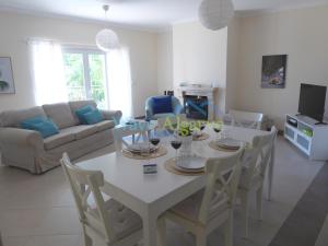 a living room with a white table and chairs at O Pomar in Cabanas by Wave Algarve in Cabanas de Tavira