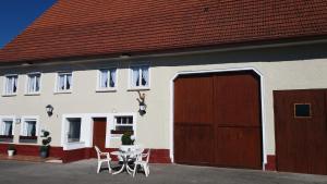 a house with a garage and a table and chairs at Monteurhotel B27 in Rottweil