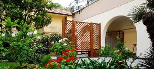 a garden with flowers and plants in front of a house at Hotel Villa Adriana in Monterosso al Mare