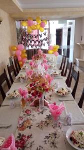 a long table with flowers and balloons on it at Family hotel Elena in Arbanasi +37 photos