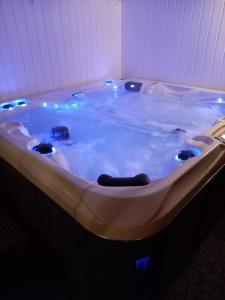 a jacuzzi tub with lights in a room at Khaki Campbell in Ermelo