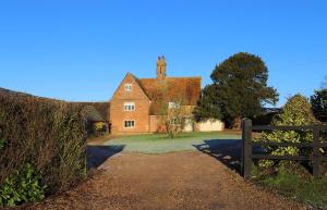 an old house with a fence in front of it at Cowley Farm, Preston Bissett, Buckingham in Buckingham