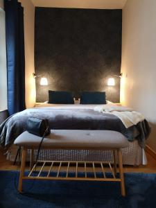 a bedroom with a large bed with two pillows at Les Suites de Sautet in Chambéry