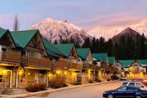 a row of buildings with mountains in the background at MountainView -PrivateChalet Sleep7- 5min to DT Vacation Home in Canmore