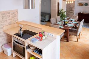 a kitchen and dining room with a table and a stove at Sa Lluna in Santanyi +27 photos