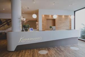 a lobby with a reception desk in a building at Kunzmann's Hotel | Spa in Bad Bocklet