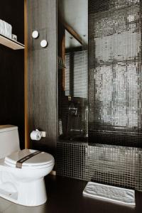 a bathroom with a toilet and a shower at The Click Clack Hotel Bogotá in Bogotá