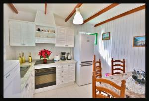 a kitchen with white cabinets and a white refrigerator at Terracitas 28 & 27 in Playa Blanca