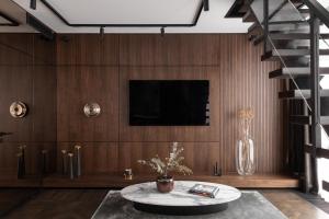 a living room with a table and a tv on a wall at A22 Hotel in Riga