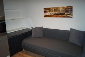 a couch in a room with a painting on the wall at FEWO Außerlechner in Innsbruck
