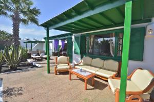 a patio with couches and a table and chairs at Terracitas 28 & 27 in Playa Blanca