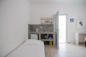 a small kitchen with a sink and a counter at Marias Rooms in Ios Chora