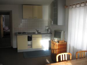 a small kitchen with a sink and a tv at Messnerwirt Onach in San Lorenzo di Sebato
