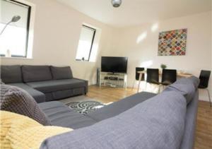 a living room with a couch and a tv at StayZo Premiere Serviced Accommodation-17 in Southampton