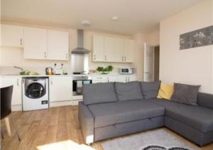 a living room with a couch and a kitchen at StayZo Premiere Serviced Accommodation-17 in Southampton