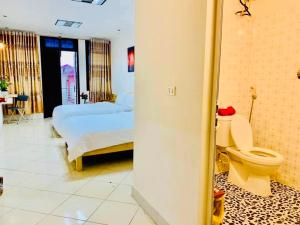 a bathroom with two beds and a toilet in a room at Lumos Home Ha noi in Hanoi +47 photos