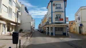 an empty street with a building on the side at Apartamentos Pátio da Aldeia in Armação de Pêra