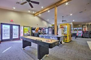 a gaming room with a ping pong table and arcade games at Family Resort Condo with Perks in Branson! in Branson