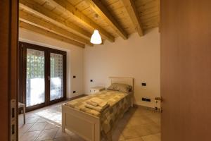 Ένα ή περισσότερα κρεβάτια σε δωμάτιο στο Albergo Diffuso Forgaria Monte Prat
