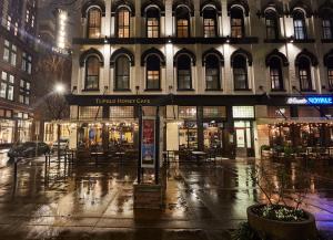 a building on a rainy city street at night at The Oliver Hotel Knoxville, by Oliver in Knoxville