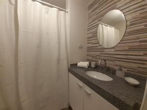 a bathroom with a sink and a mirror at Departamento a estrenar in San Miguel de Tucumán