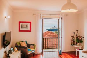 a living room with a view of a cruise ship at Funchal Old Town Apartments 2.8 in Funchal