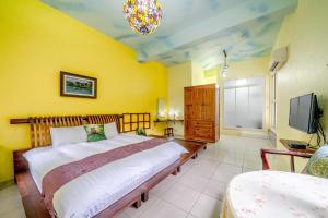 Postel nebo postele na pokoji v ubytování Yi Jing B&B