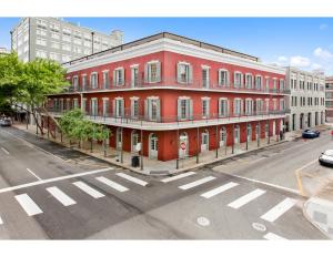 a red building on the corner of a street at The Livingston in New Orleans