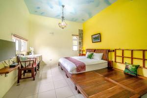 Postel nebo postele na pokoji v ubytování Yi Jing B&B